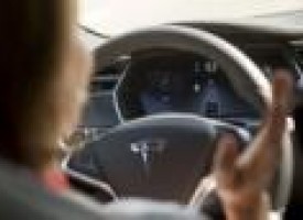 Tesla unveils autopilot system, but don't let go of the wheel